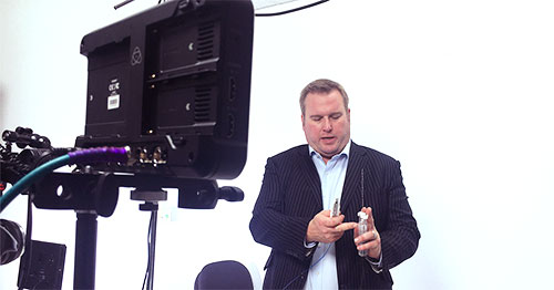 Ian Quirk from Active Needle Technology manexplaining his product infront of a video camera